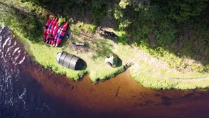 Aerial camp with tents boats and people