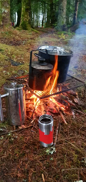 Fire tarp and people during expedition camp life